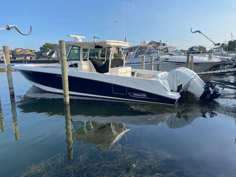 Slide: The Image of 2014 Boston Whaler 370 Outrage boat docked in a marina. - 6