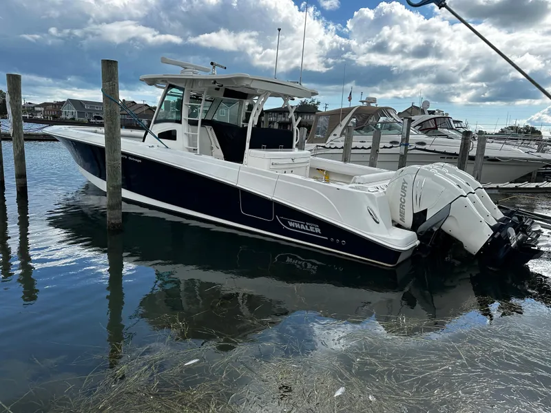 Slide: The Image of 2014 Boston Whaler 370 Outrage docked at a marina. - 7