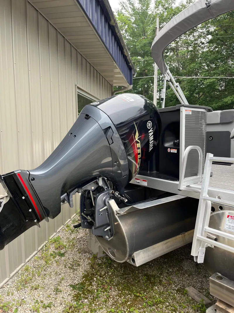 Slide: The Image of 2024 Bennington 22 SS SPS pontoon boat with Yamaha outboard motor, parked outdoors. - 11