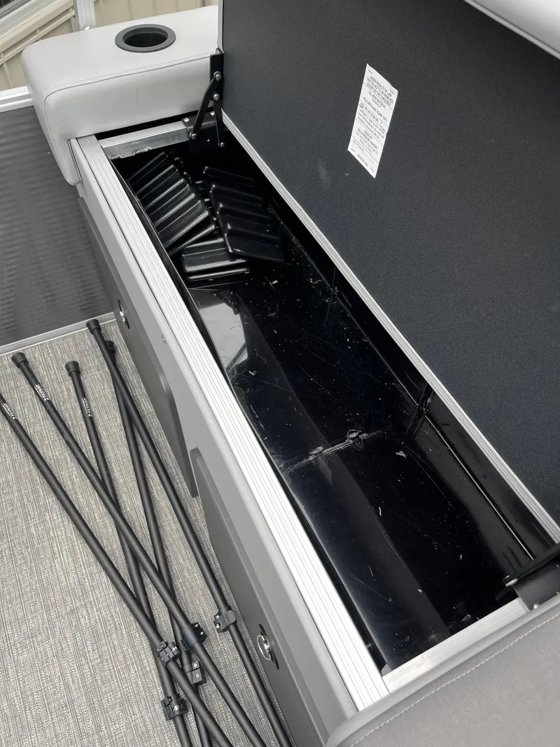 Slide: The Image of Open storage compartment in 2024 Bennington 22 SS SPS boat with rods on the floor. - 4
