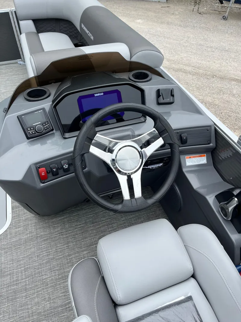 Slide: The Image of 2024 Bennington 22 SS SPS boat dashboard with steering wheel and control panel. - 9