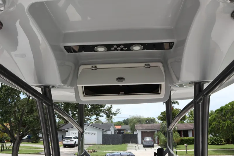 Slide: The Image of 2016 Sea Fox Commander 288 boat interior with overhead storage and control panel. - 18