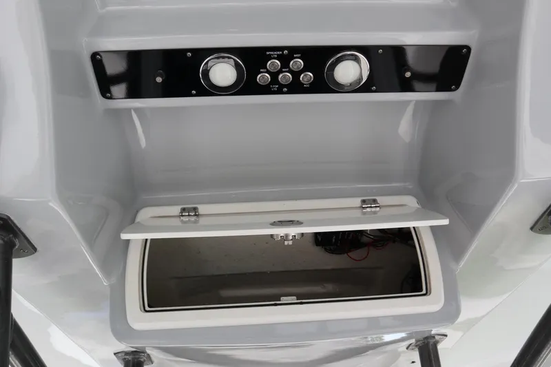 Slide: The Image of 2016 Sea Fox Commander 288 console with open storage compartment and control panel. - 19