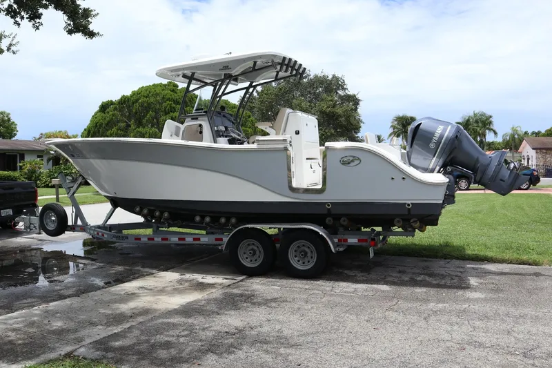 Slide: The Image of 2016 Sea Fox Commander 288 boat on trailer, parked in residential area. - 2