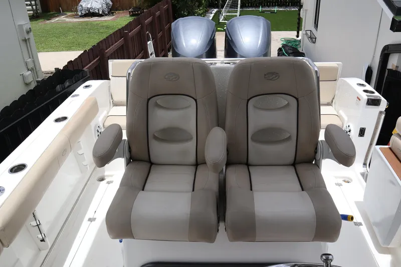 Slide: The Image of 2016 Sea Fox Commander 288 boat seats with armrests, featuring dual outboard motors. - 20