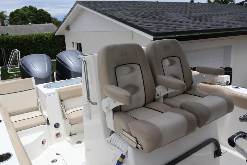 Slide: The Image of 2016 Sea Fox Commander 288 boat with dual seats and Yamaha engines in a residential setting. - 21