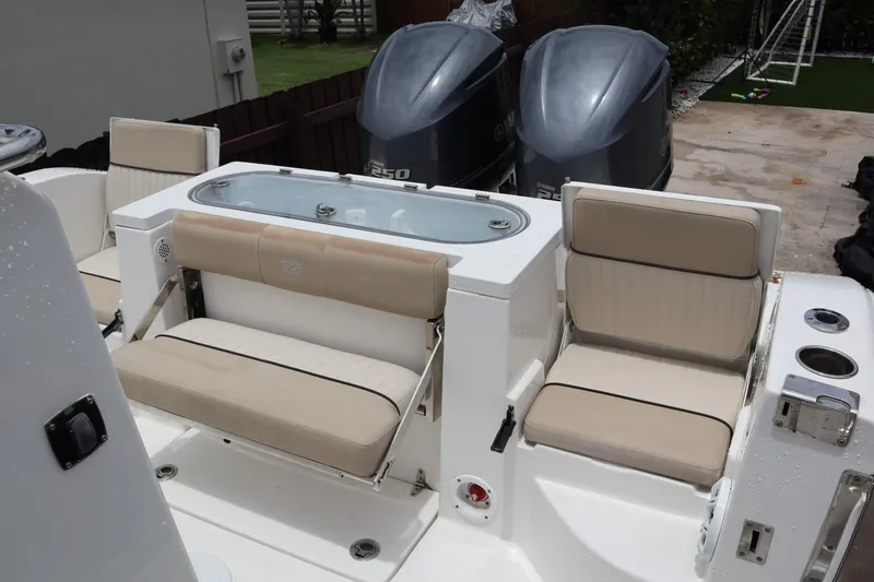 Slide: The Image of 2016 Sea Fox Commander 288 boat interior with seating and dual Yamaha engines. - 22