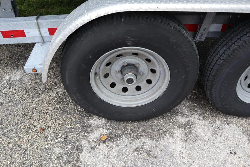 Slide: The Image of Trailer wheel of 2016 Sea Fox Commander 288 on gravel surface. - 32