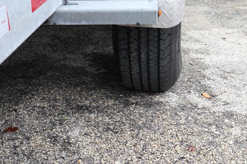 Slide: The Image of Trailer tire on pavement, part of a 2016 Sea Fox Commander 288. - 33