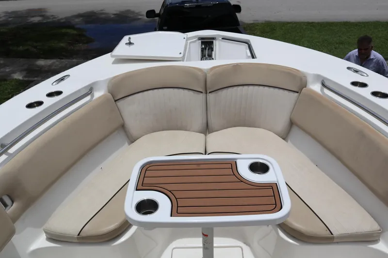 Slide: The Image of 2016 Sea Fox Commander 288 boat interior with cushioned seating and a wooden table. - 7