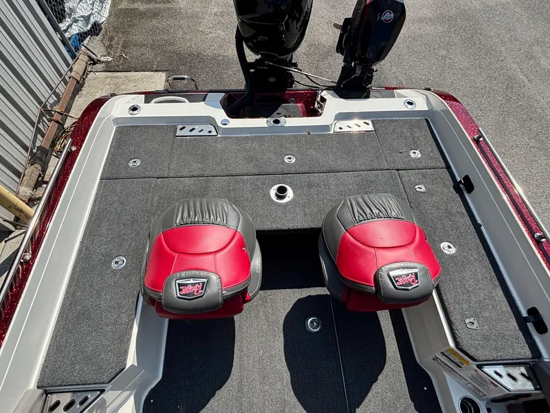 Slide: The Image of 2021 Ranger 621cFS Pro boat deck with red and black seats, motor visible. - 11