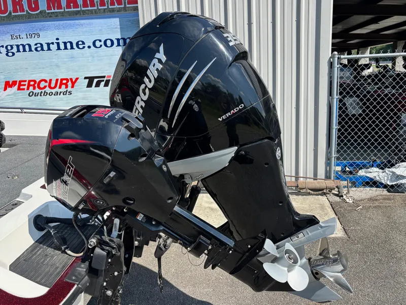 Slide: The Image of 2021 Ranger 621cFS Pro with Mercury Verado outboard motor, parked near a marine shop. - 12