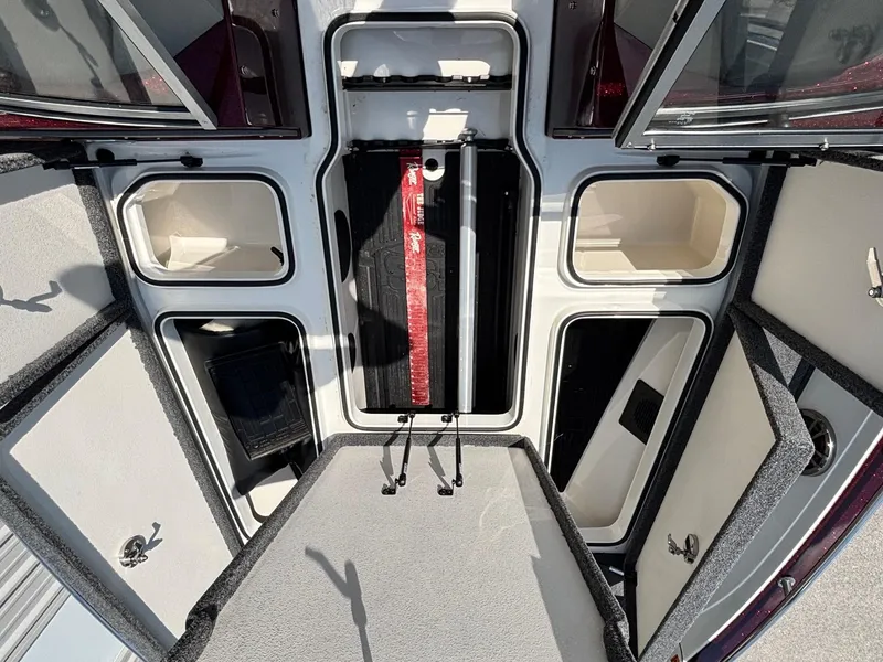 Slide: The Image of 2021 Ranger 621cFS Pro boat storage compartments with open hatches and organized interior layout. - 7