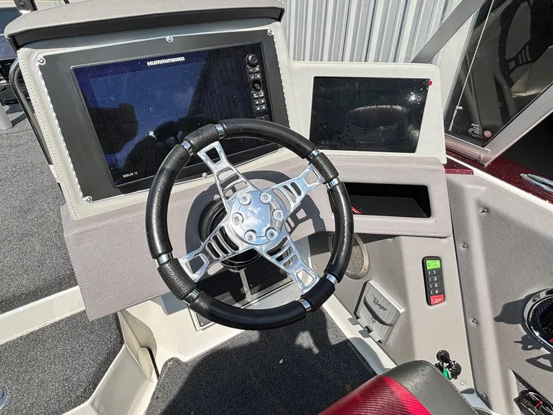 Slide: The Image of 2021 Ranger 621cFS Pro boat dashboard with steering wheel and electronic displays. - 9