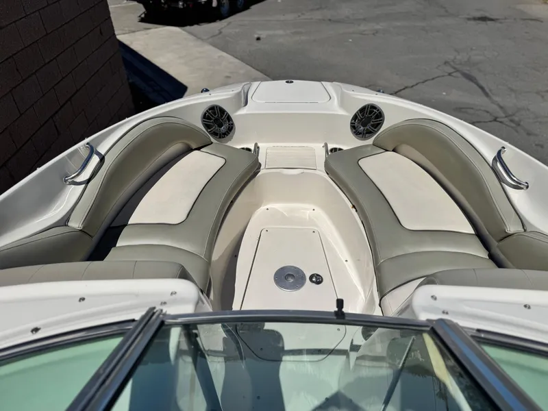 Slide: The Image of 2005 Sea Ray 220 Sundeck boat interior with cushioned seating and speakers. - 11