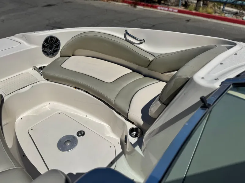 Slide: The Image of 2005 Sea Ray 220 Sundeck interior with cushioned seating and speaker. - 13