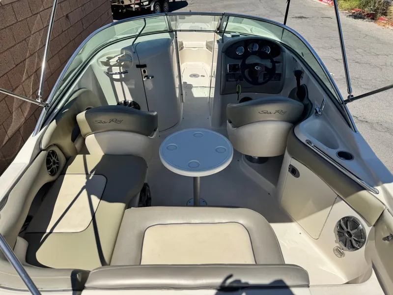 Slide: The Image of 2005 Sea Ray 220 Sundeck interior with seating, table, and steering wheel. - 15