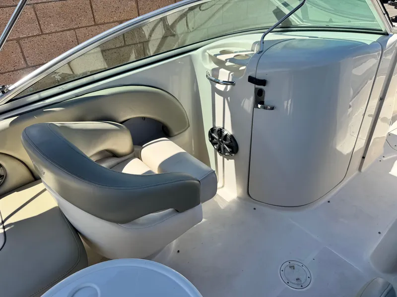 Slide: The Image of 2005 Sea Ray 220 Sundeck interior with seating and console details. - 23