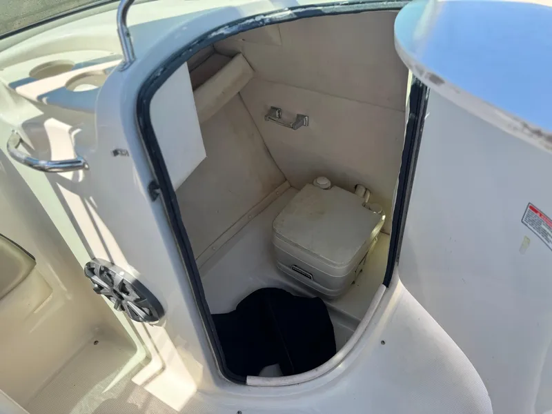 Slide: The Image of 2005 Sea Ray 220 Sundeck boat interior with compact toilet compartment. - 24