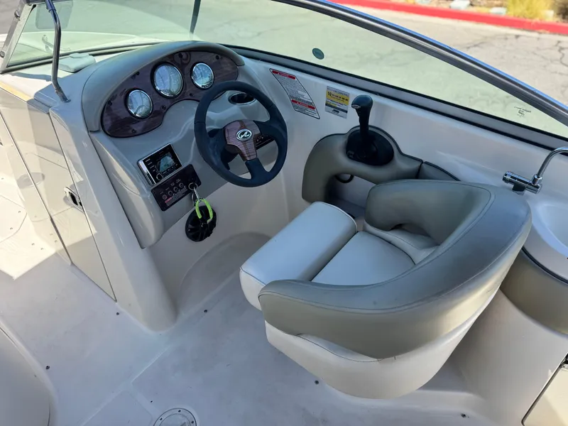 Slide: The Image of 2005 Sea Ray 220 Sundeck boat cockpit with steering wheel and gauges. - 25