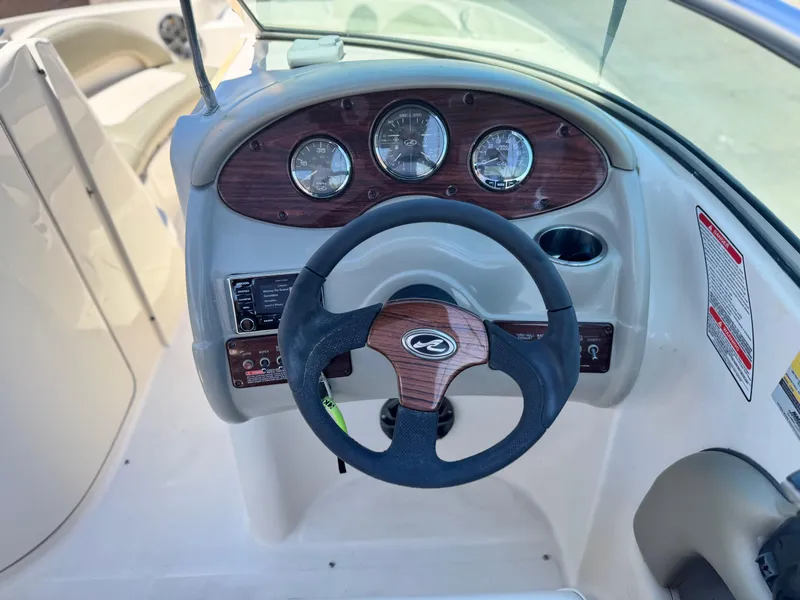Slide: The Image of Steering wheel and dashboard of 2005 Sea Ray 220 Sundeck boat. - 26