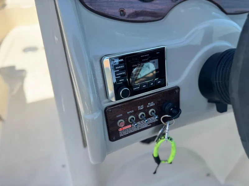 Slide: The Image of Control panel of a 2005 Sea Ray 220 Sundeck boat with stereo and switches. - 27