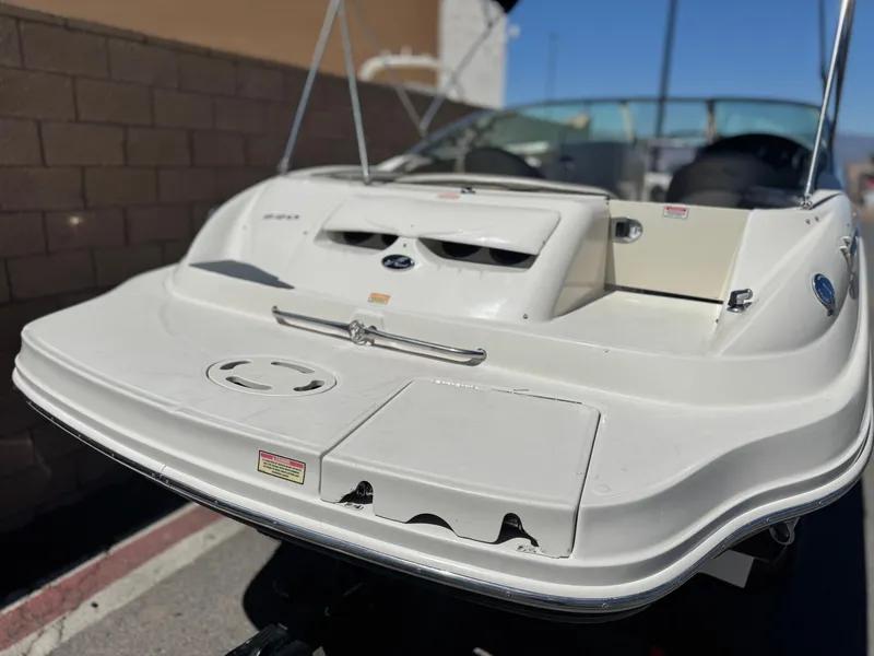 Slide: The Image of 2005 Sea Ray 220 Sundeck boat, rear view, white exterior, parked outdoors. - 6