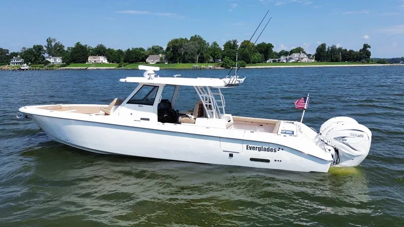 The Image of 2023 Everglades 395 Center Console boat on water, featuring sleek design and powerful engines. - 0