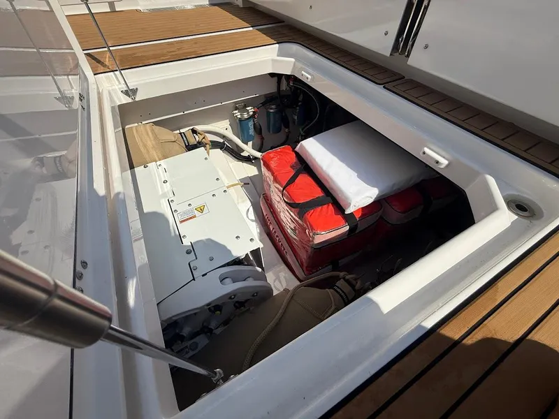 Slide: The Image of Open storage compartment on 2023 Everglades 395 Center Console boat, showing equipment and supplies. - 14