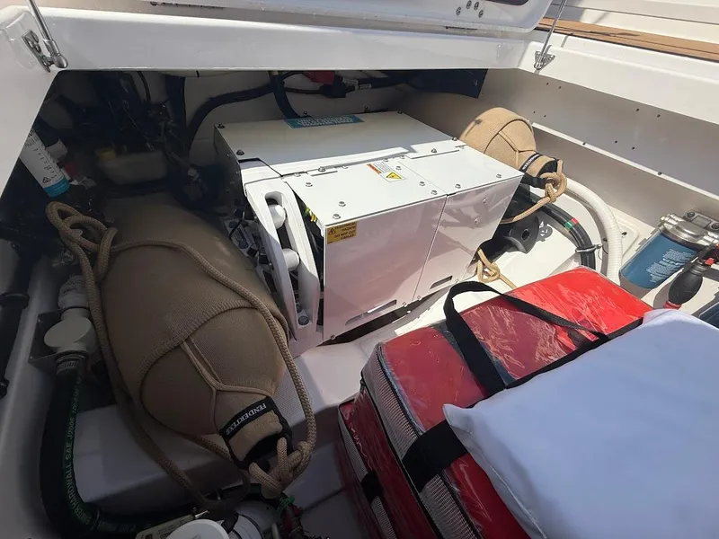 Slide: The Image of 2023 Everglades 395 Center Console engine compartment with equipment and storage. - 15