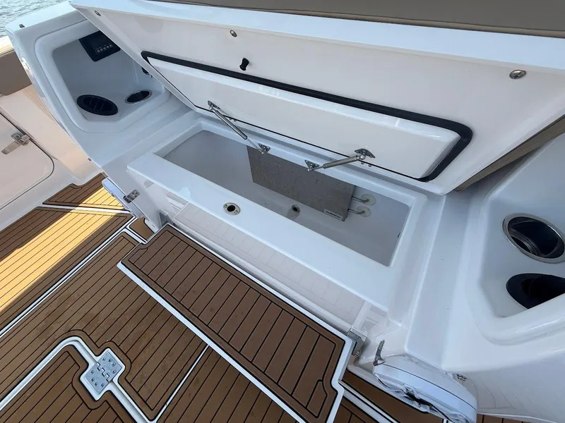 Slide: The Image of 2023 Everglades 395 Center Console boat with open storage compartment and teak flooring. - 17