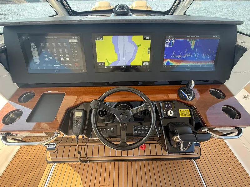Slide: The Image of 2023 Everglades 395 Center Console dashboard with advanced navigation displays and controls. - 20