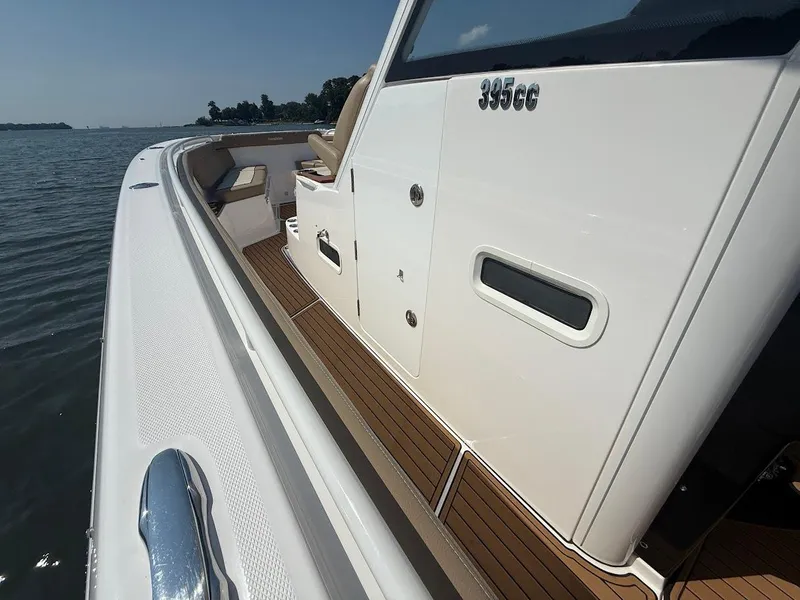 Slide: The Image of 2023 Everglades 395 Center Console boat with sleek design and wooden deck details. - 21