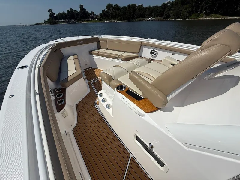 Slide: The Image of 2023 Everglades 395 Center Console boat interior with luxurious seating and wood accents. - 26