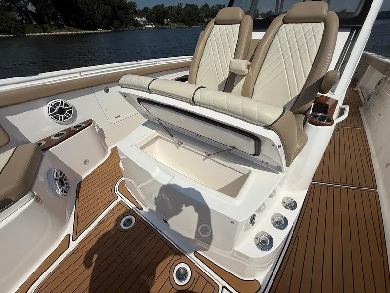 Slide: The Image of 2023 Everglades 395 Center Console boat interior with luxury seating and storage compartment. - 28