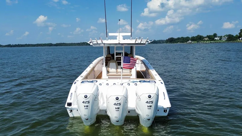 Slide: The Image of 2023 Everglades 395 Center Console boat with triple 425 V8 engines on open water. - 3