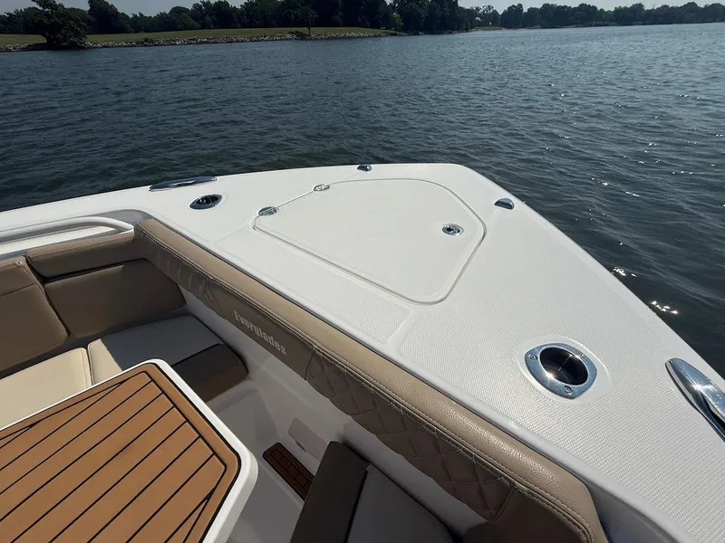 Slide: The Image of 2023 Everglades 395 Center Console boat interior with seating and table on a lake. - 31