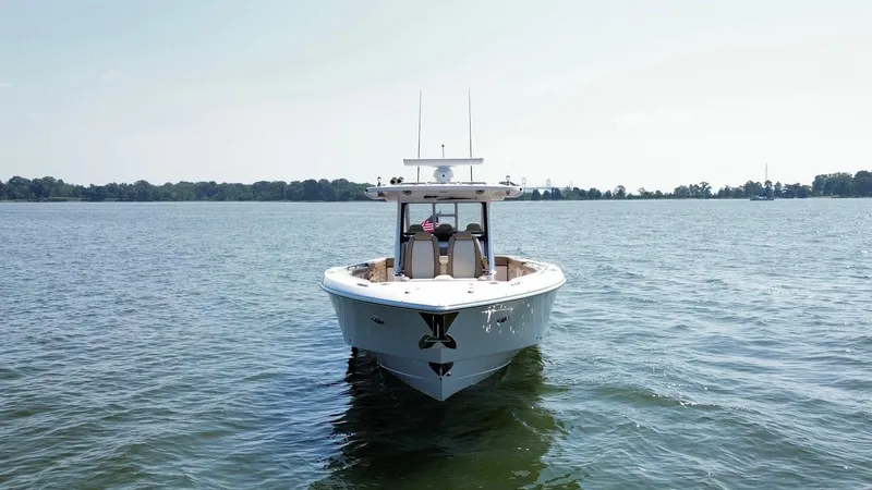 Slide: The Image of 2023 Everglades 395 Center Console boat on open water, front view. - 6