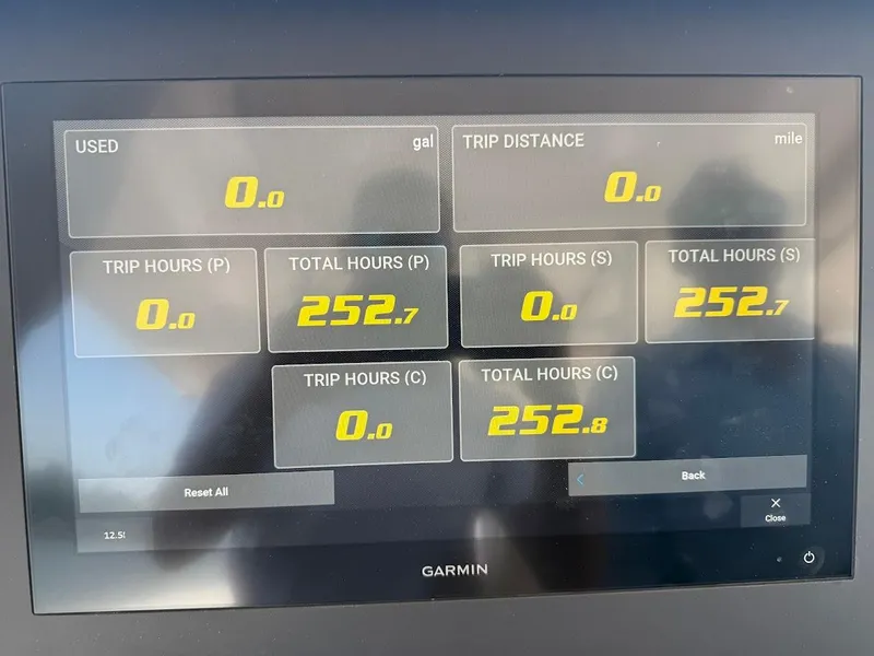 Slide: The Image of Garmin display on 2023 Everglades 395 Center Console showing trip and total hours data. - 8