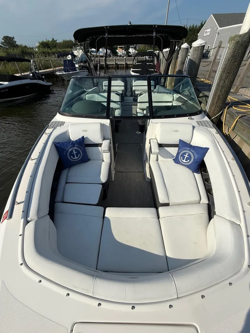 Slide: The Image of 2017 Regal 29 OBX boat with white seating and nautical-themed cushions. - 12