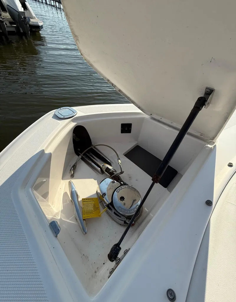 Slide: The Image of Open storage compartment on a 2017 Regal 29 OBX boat, docked by the water. - 13