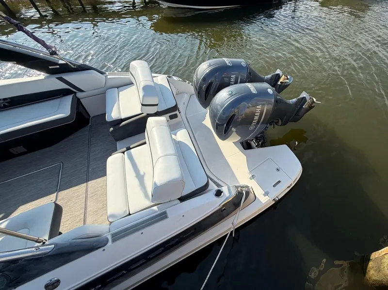 Slide: The Image of 2017 Regal 29 OBX boat with dual Yamaha outboard engines, docked on calm water. - 3