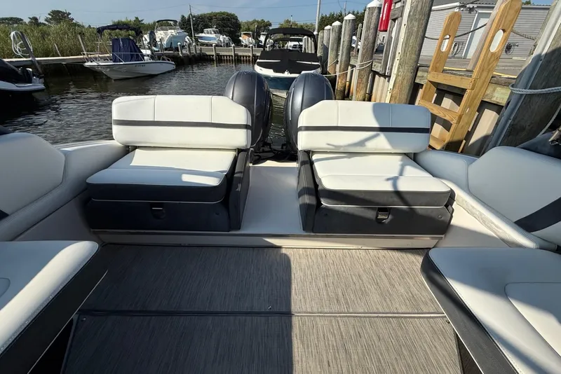 Slide: The Image of 2017 Regal 29 OBX boat interior with white seating and dual outboard motors. - 4