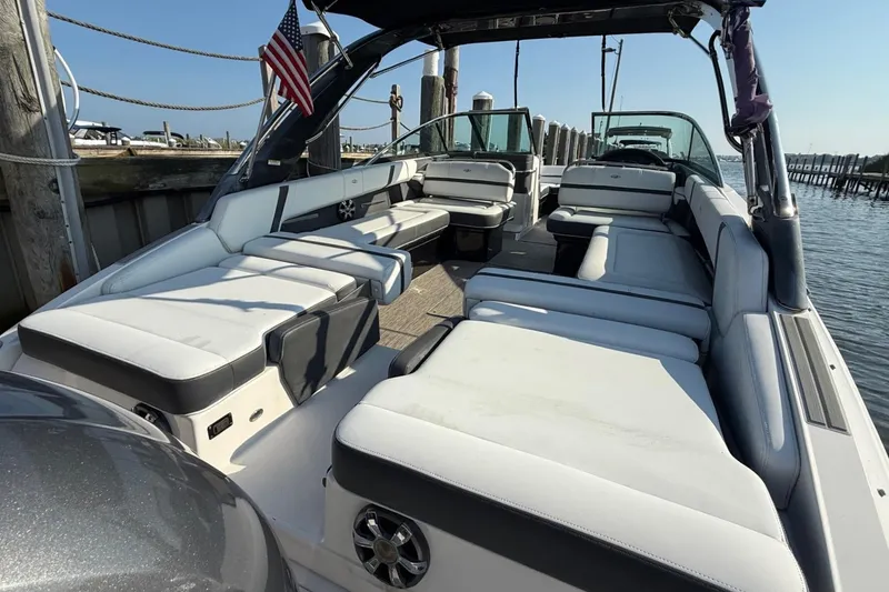 Slide: The Image of 2017 Regal 29 OBX boat with spacious seating, docked by the water. - 5