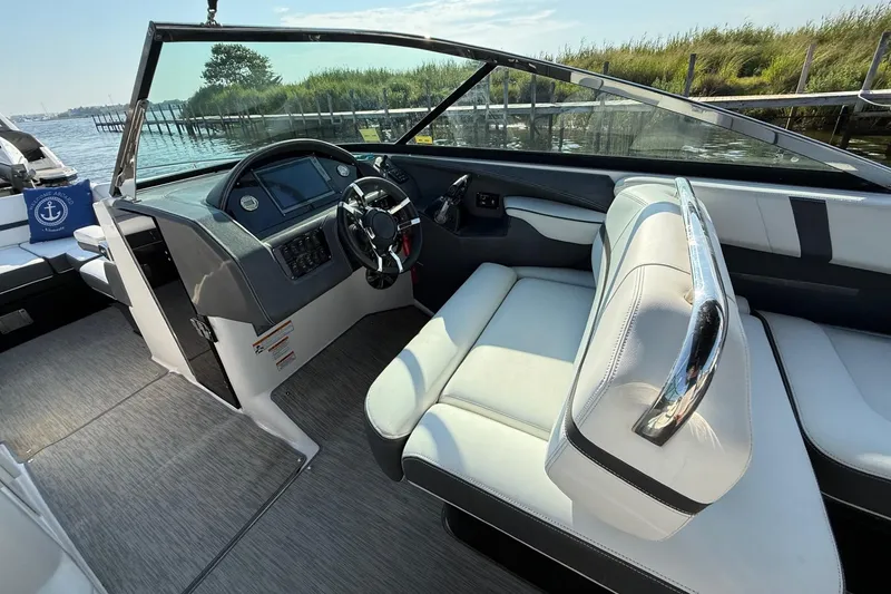 Slide: The Image of 2017 Regal 29 OBX boat interior with sleek dashboard and comfortable seating. - 9