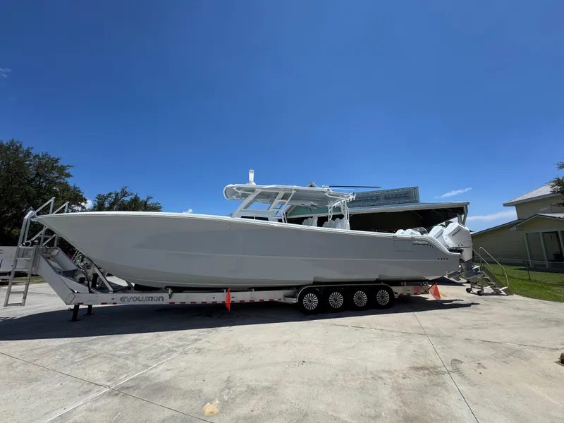 The Image of 2026 Invincible 46 Catamaran on trailer under clear blue sky. - 1