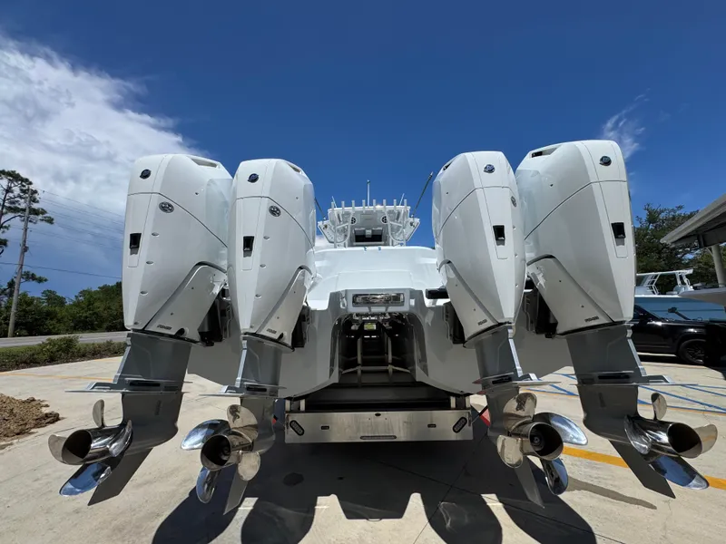 Slide: The Image of 2026 Invincible 46 Catamaran with four powerful outboard engines, docked under a clear blue sky. - 14