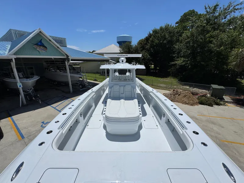 Slide: The Image of 2026 Invincible 46 Catamaran docked at a marina under clear blue skies. - 18