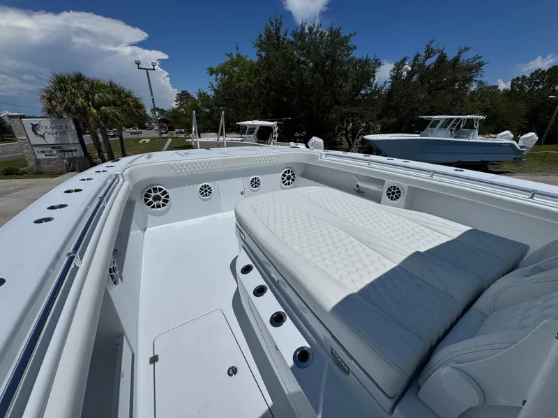 Slide: The Image of 2026 Invincible 46 Catamaran with spacious seating and sleek design in a marina setting. - 21