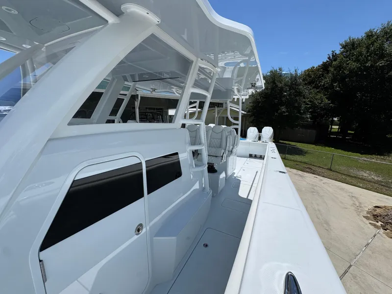 Slide: The Image of 2026 Invincible 46 Catamaran with sleek white design and spacious deck layout. - 22
